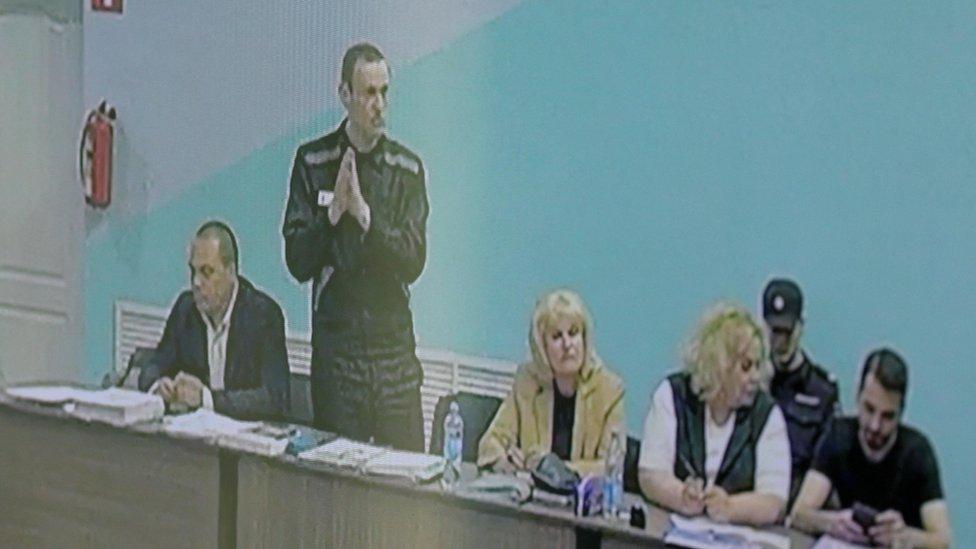 Russian opposition politician Alexei Navalny, his lawyers Olga Mikhailova and Vadim Kobzev and other participants are seen on a screen via a video link during an external hearing of the Moscow City Court in a new criminal case against Navalny on numerous charges, including the creation of an extremist organization, at the IK-6 penal colony in the Vladimir region, Russia, June 19, 2023.