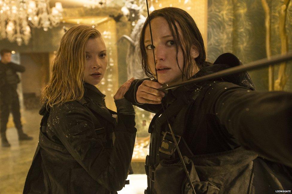 Natalie Dormer as Cressida and Jennifer Lawrence as Katniss Everdeen