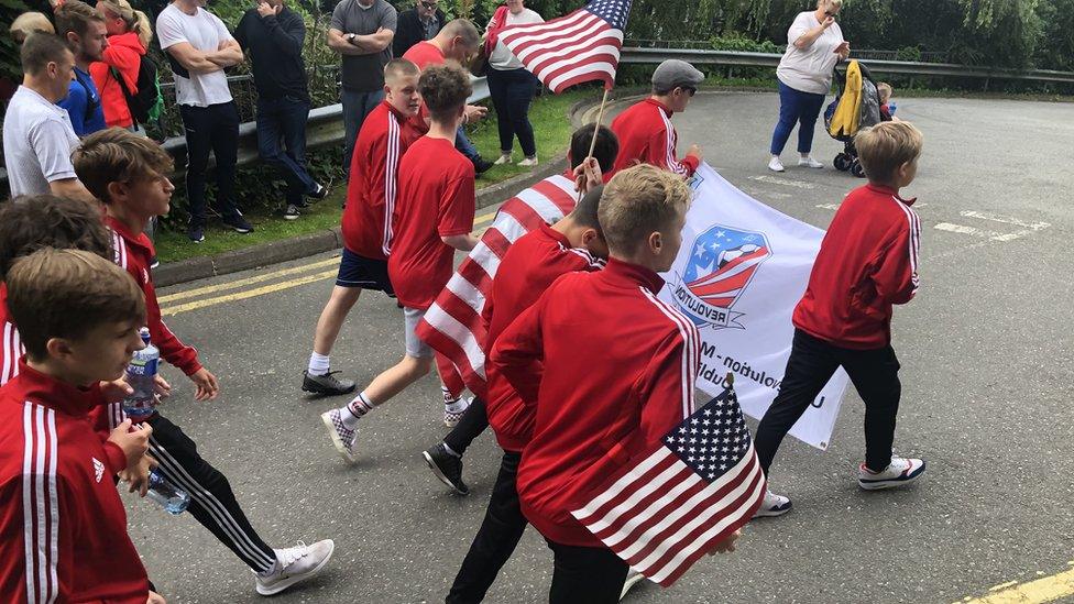 football players waving american flags