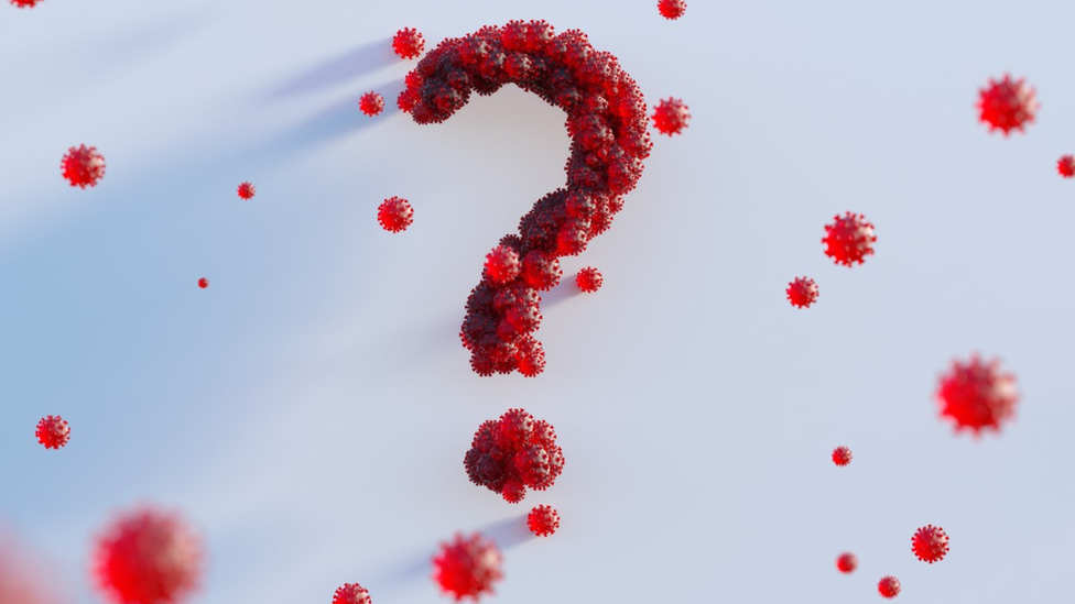 a question mark made up of virus particles.