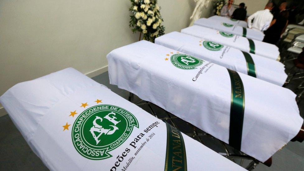 Blankets bearing the crest of Brazilian soccer team Chapecoense are placed on coffins in Medellin, Colombia December 1, 2016.