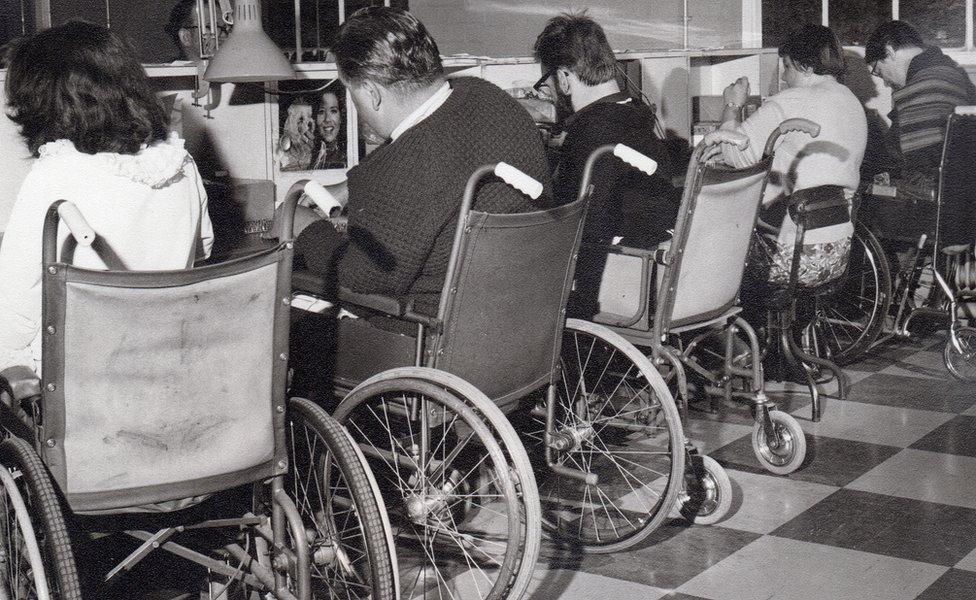 five wheelchair users working