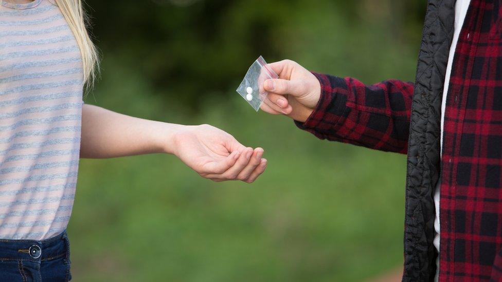 Anonymous boy selling drugs to girl