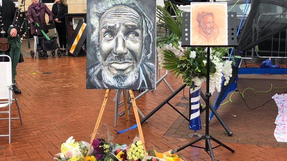 paintings and flowers at a funeral service