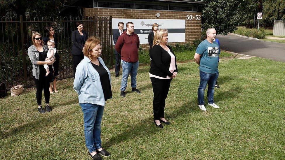 Relatives of residents at Newmarch House stand socially distanced