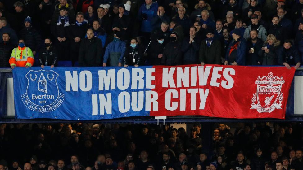 Banner reading 'no more knives in our city'