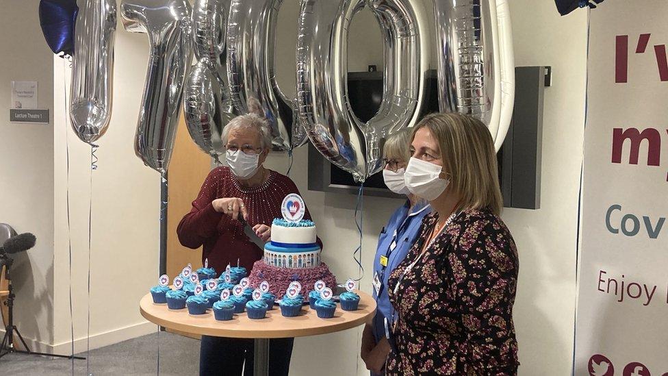 Ann Allen cutting the anniversary cake