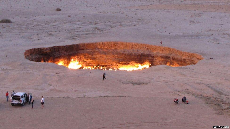 Massive crater with fire in the middle