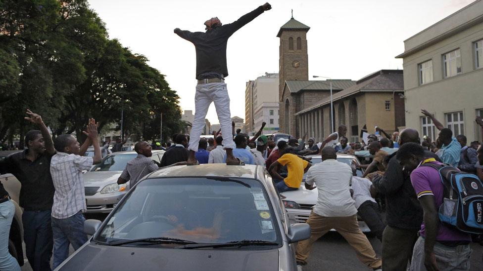 Man on car in Harare