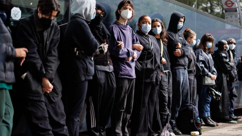 Protesters surround a bus that was due to transport asylum seekers from a hotel in Peckham