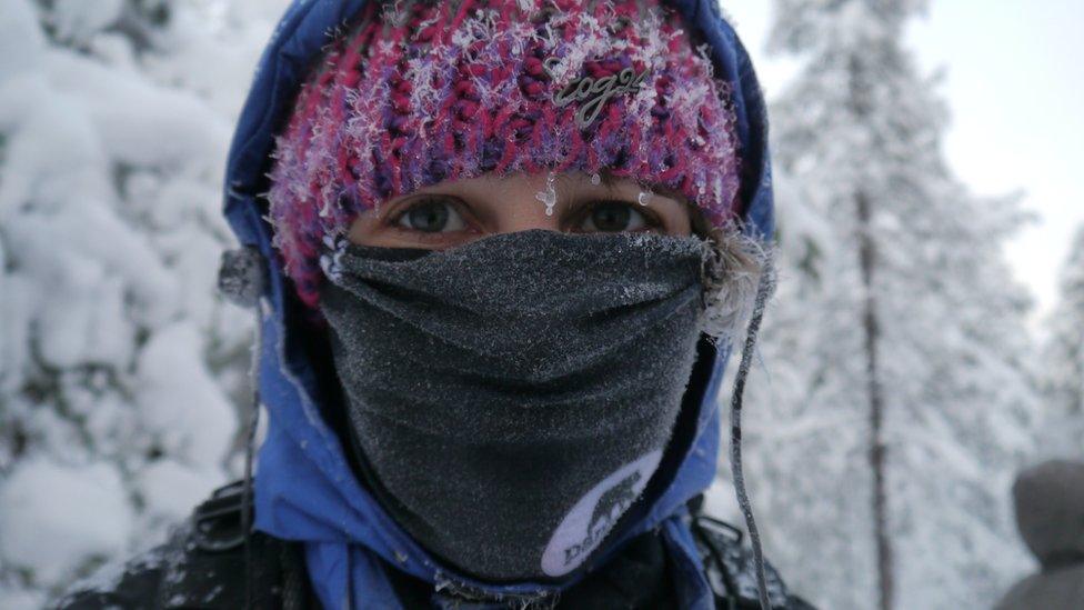 Wearing a scarf over the nose and mouth