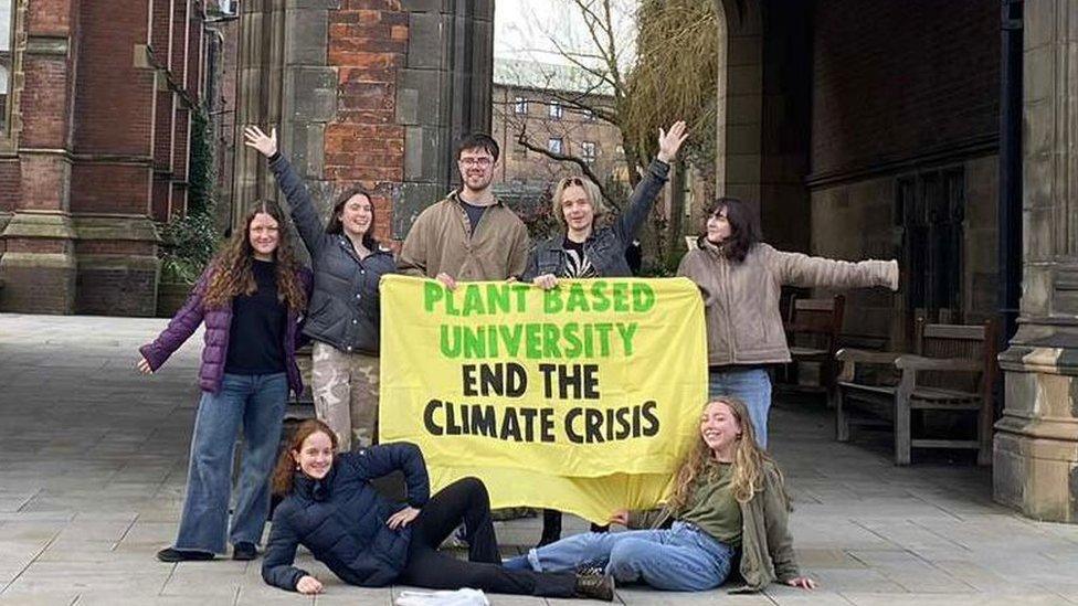 Students holding a banner in favour of the plans