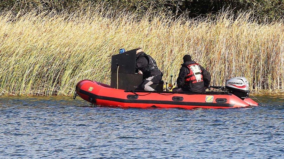 Officers search the lake