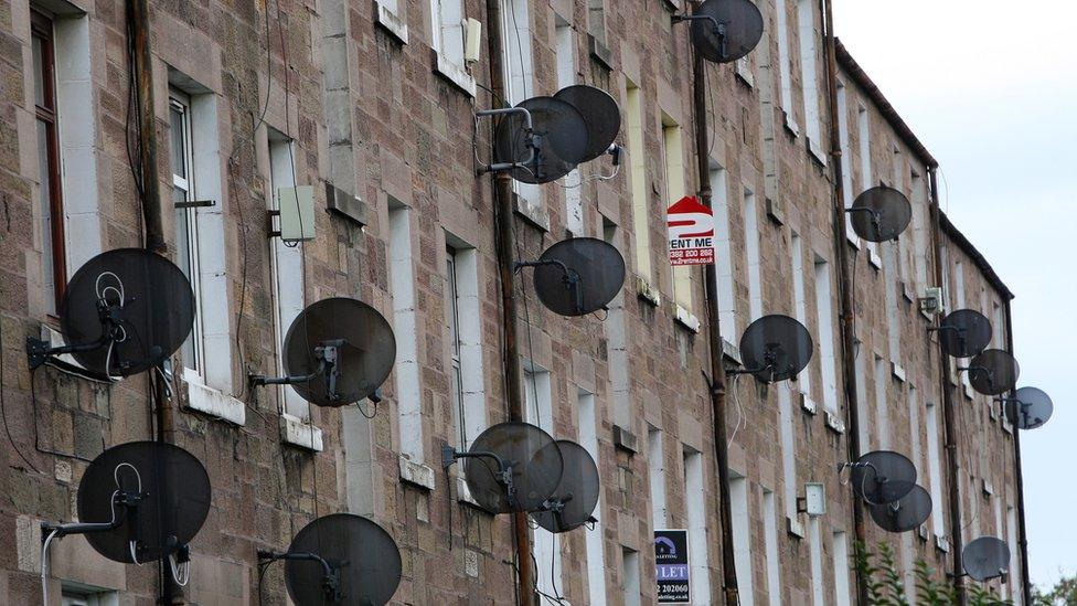 General view of homes with TV satellite dishes, Dundee, Scotland.