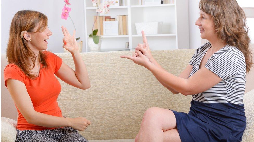 Two people using sign language