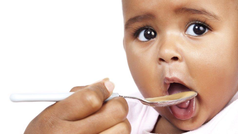 Baby being spoonfed