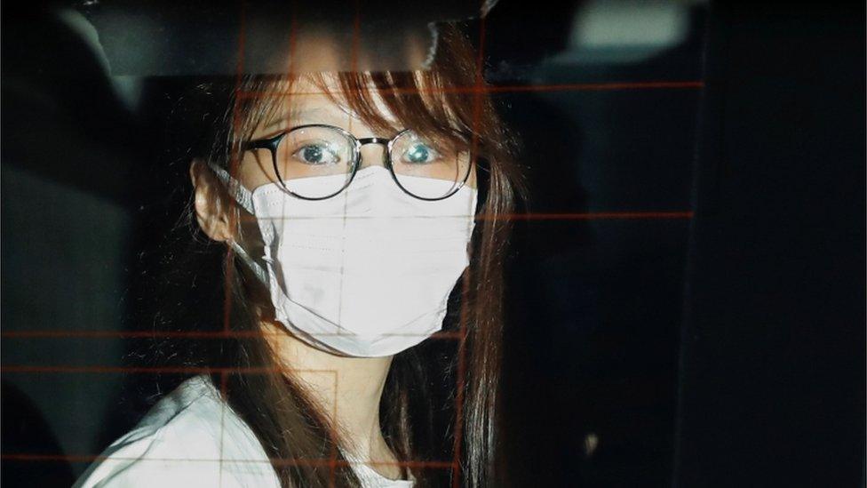 Agnes Chow in a police car in Hong Kong