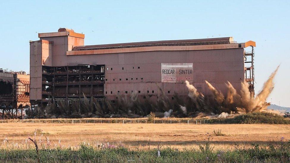 Dust exploding from bottom of building