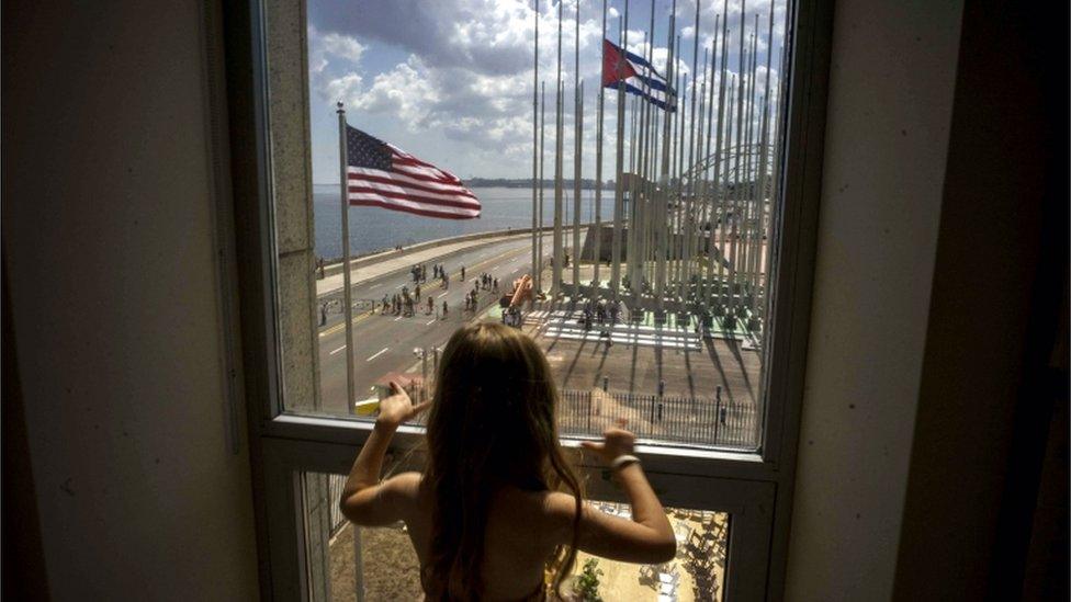 A child looks out a window from inside the newly opened US embassy overlooking the staging area on 14 August 2015