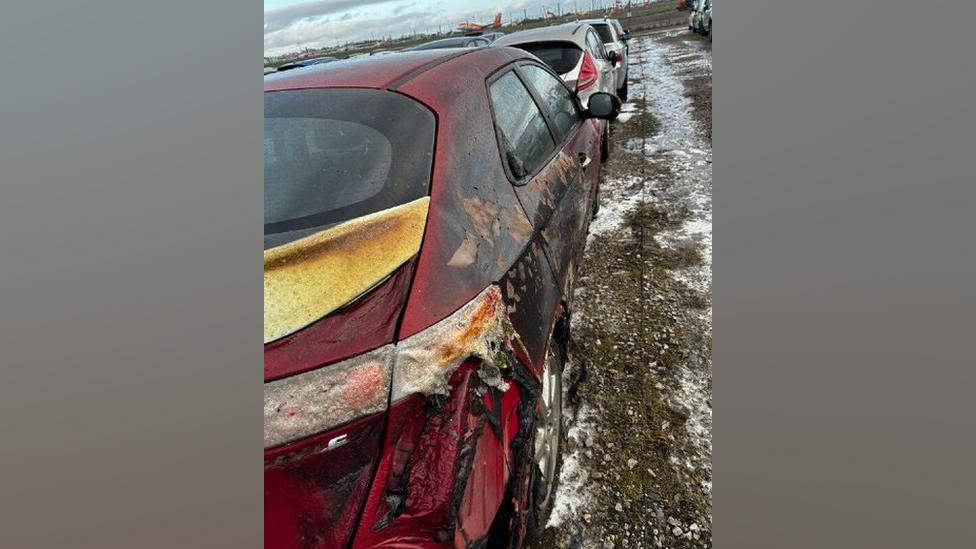 A red car badly burnt