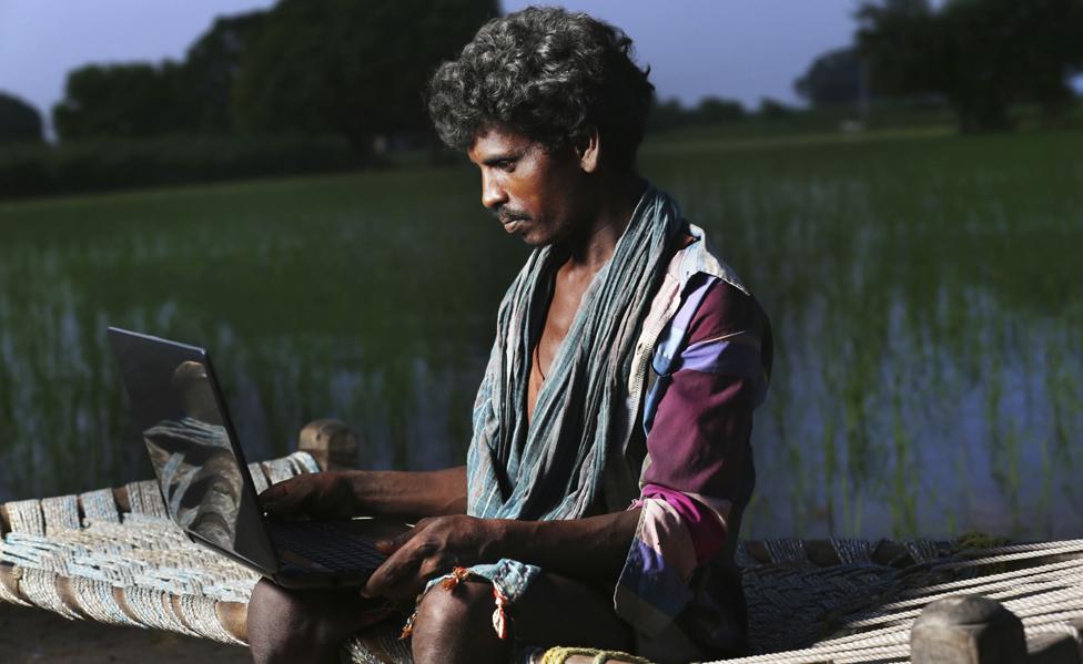 Young farmer in India using the internet