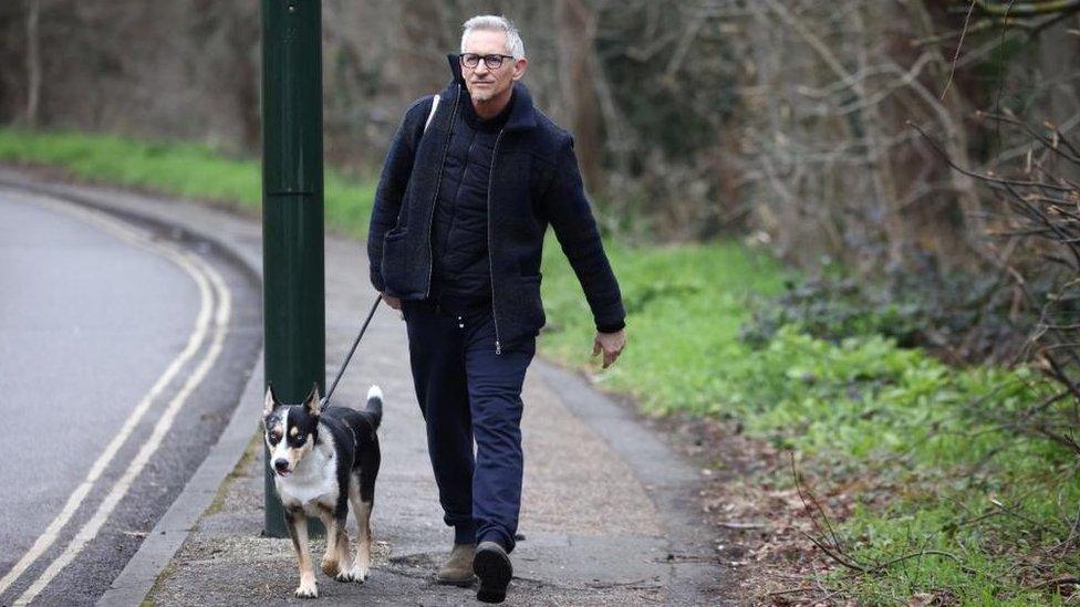 Gary Lineker walking with his dog