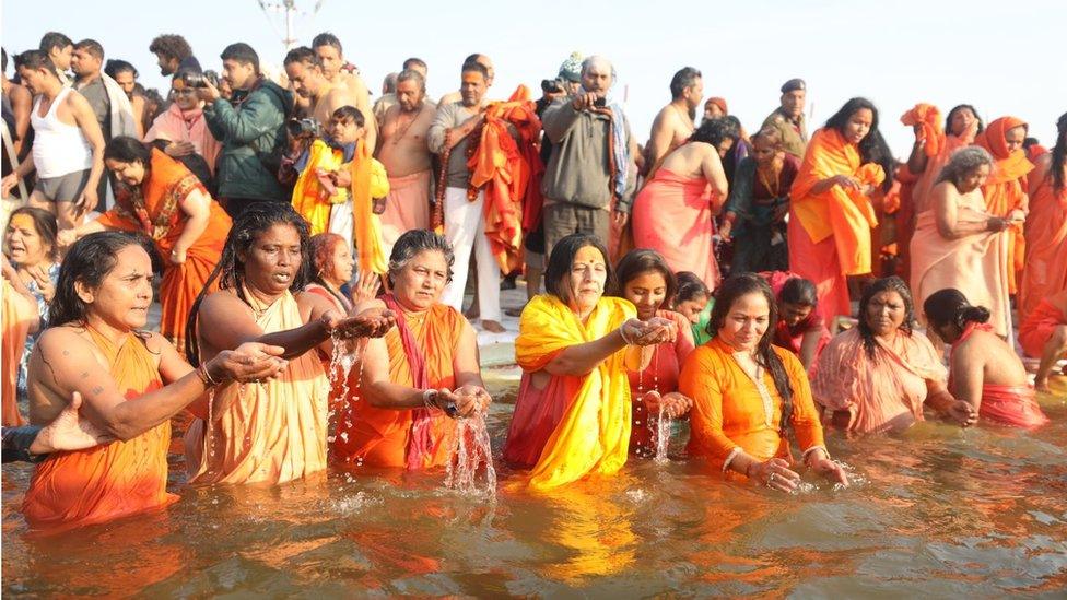 Women taking a dip at the Sangam