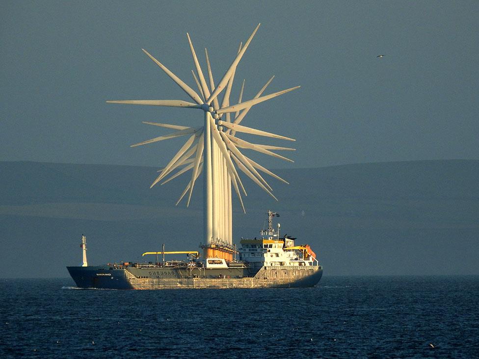 Sea wind turbines seen in a line