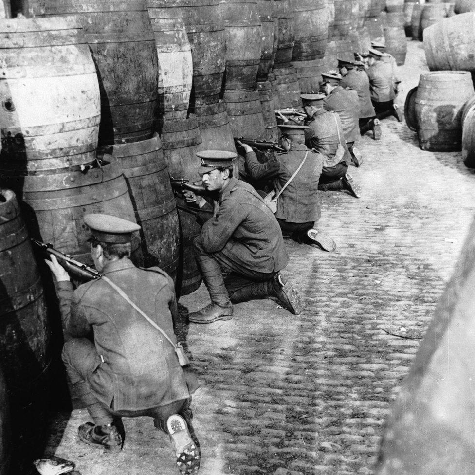 British Regulars sniping from behind a barricade of empty beer casks near the quays in Dublin during the 1916 Easter Rising