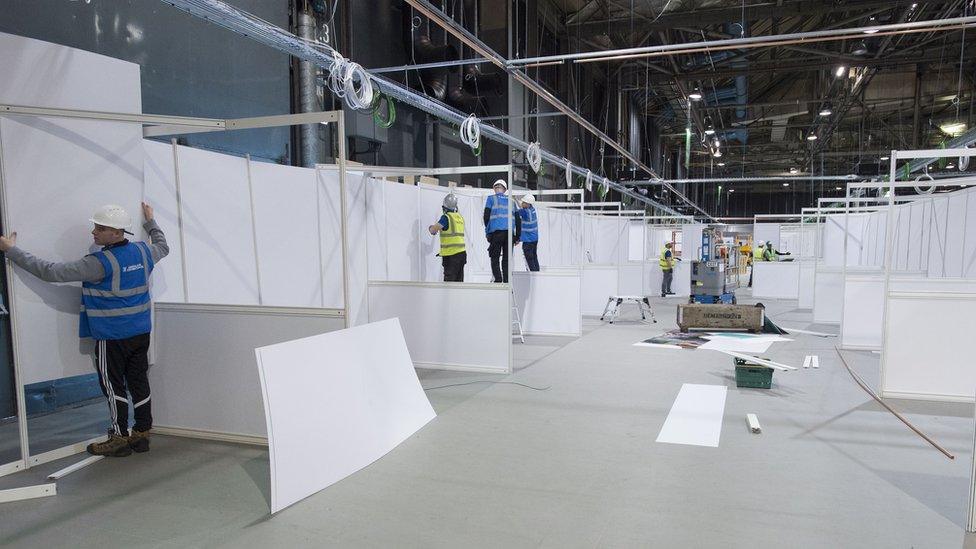 Workers building the interior of the new temporary NHS Louisa Jordan Hospital at the SEC event centre on April 07, 2020 in Glasgow, Scotland.