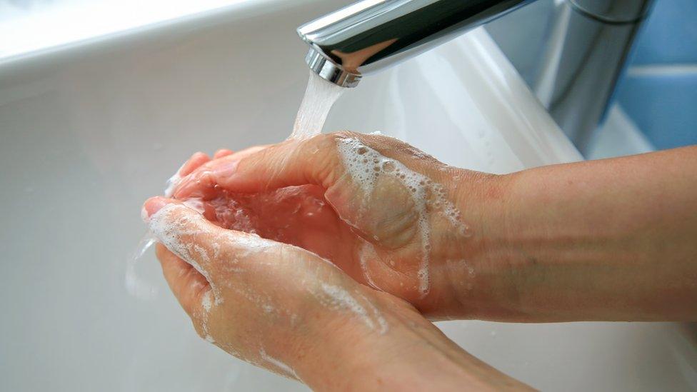 Washing hands after using the toilet