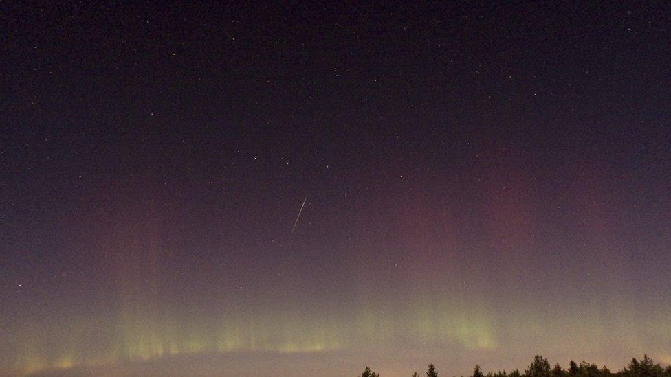 A Draconid meteor shower with the northern lights.