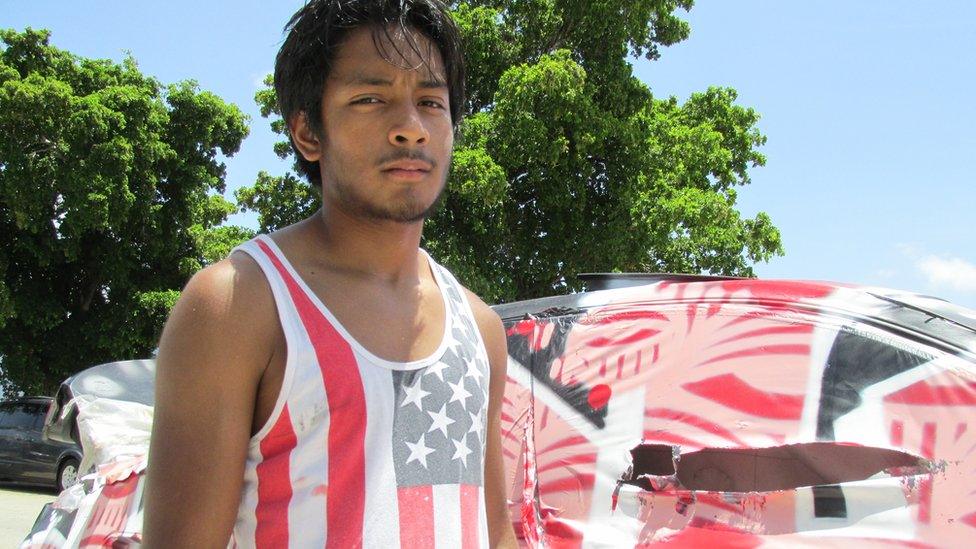 Jeffrey Romero working at his family's garage