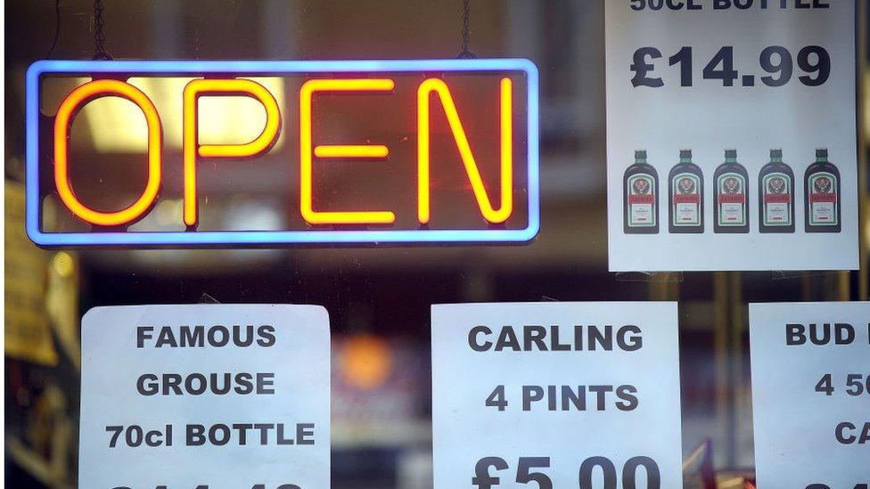 Price tags announcing special prices are displayed at a liquor store in Glasgow