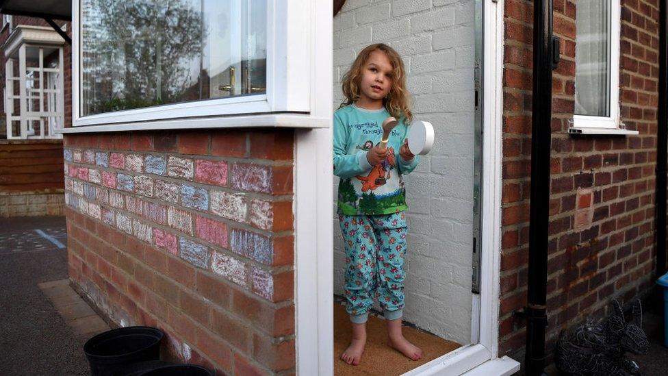 Lois Copley-Jones aged 5, daughter of the photographer claps on her doorstep as part of 'Clap for Carers’ in support of the NHS on April 16, 2020 in Newcastle Under Lyme, United Kingdom.