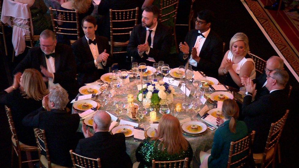 The leaders of the main Stormont parties and US delegates sit around a table at a gala dinner in Washington DC