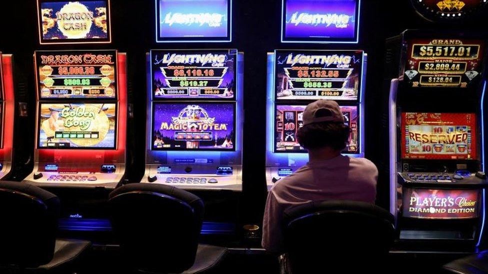 A man plays the pokies in Australia