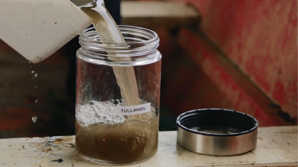 Water from the Tullahan river is poured into a container