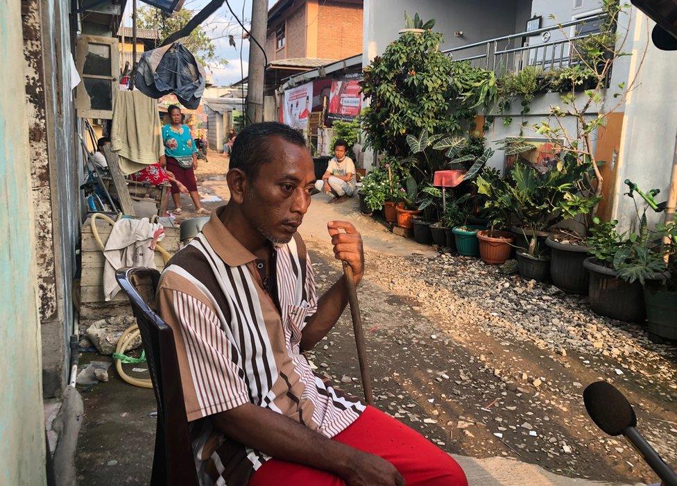 Kardi sitting in the street near his home