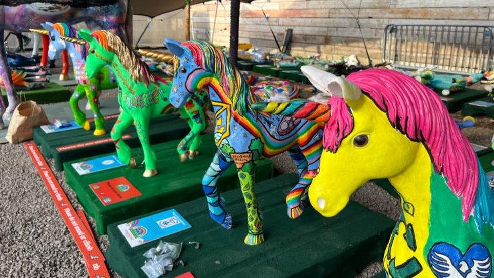 A group of decorated unicorn sculptures