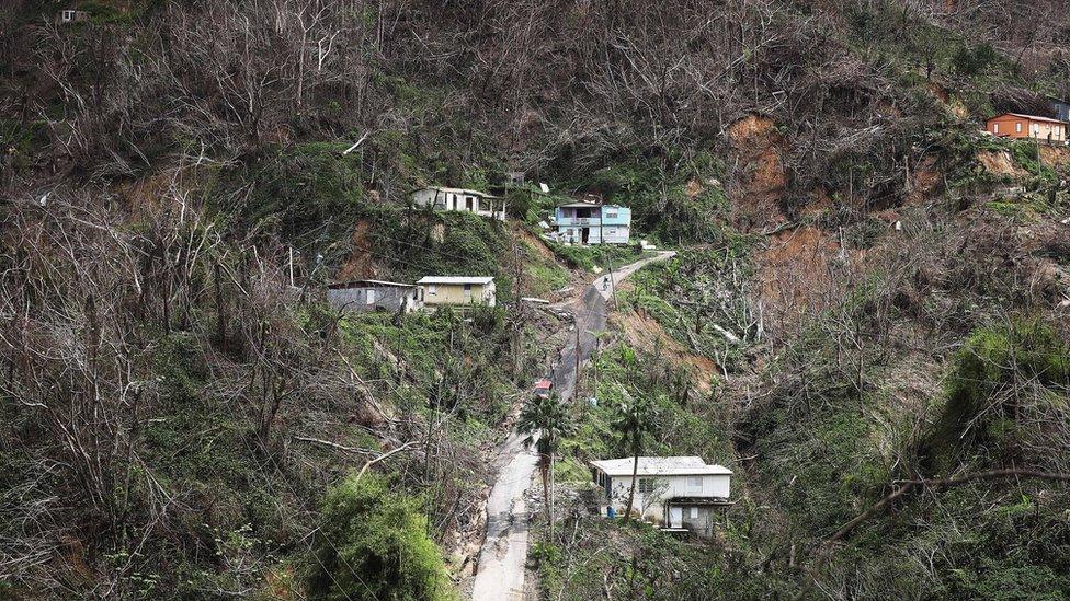 Community members gather on the street nearly three weeks after Hurricane Maria hit the island, on October 10, 2017 in Pellejas, Adjuntas municipality, Puerto Rico.