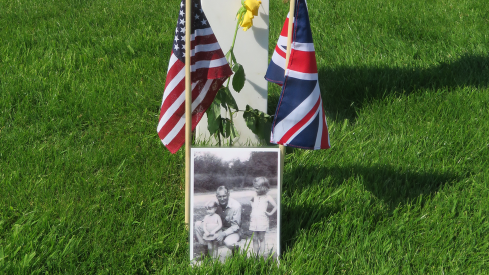 A grave with an old photo at the Cambridge American Cemetery in Cambridge, England