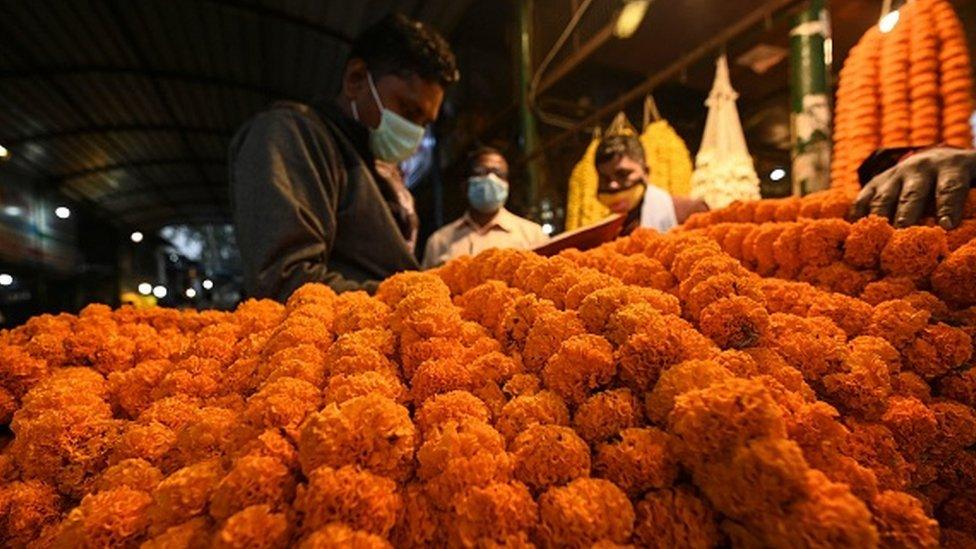 Flower garlands are displayed at a shop at a flower market ahead of Diwali, the Hindu festival of lights, in New Delhi on October 31, 2021.