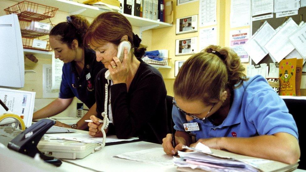 nurses at nurse station on phone