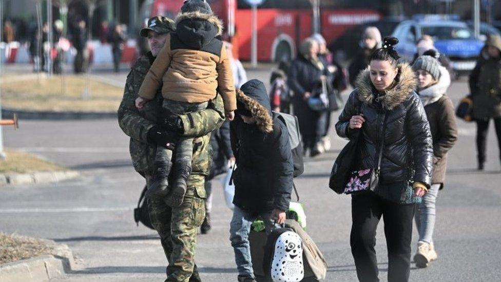 People fleeing the conflict arrive at the Polish-Ukrainian border in Medyka