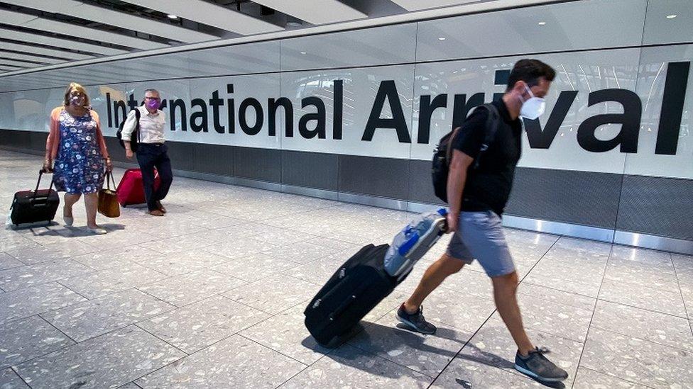 Passengers in the arrivals section of Heathrow Airport