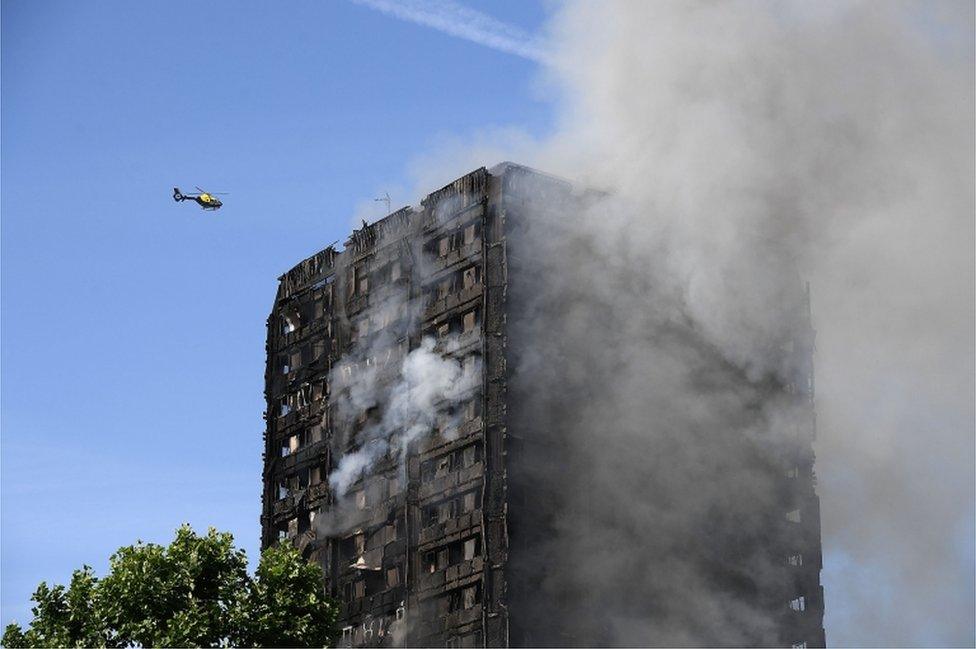 Helicopter circles Grenfell Tower