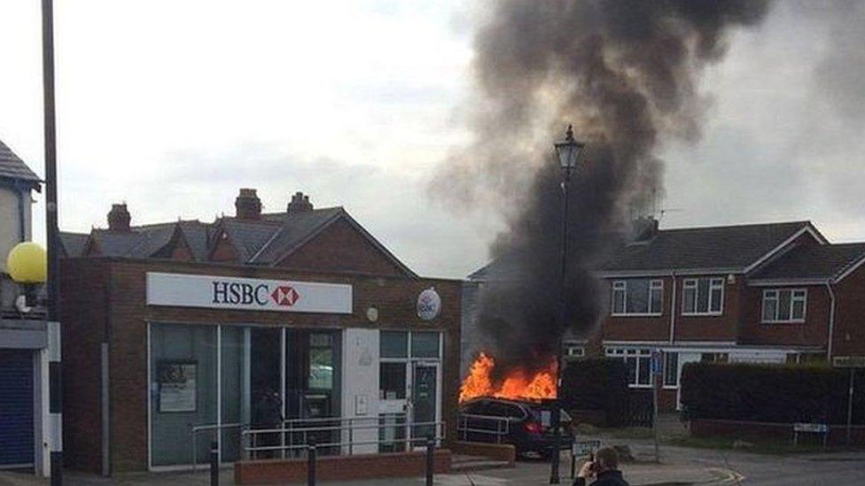 car on fire next to HSBC bank