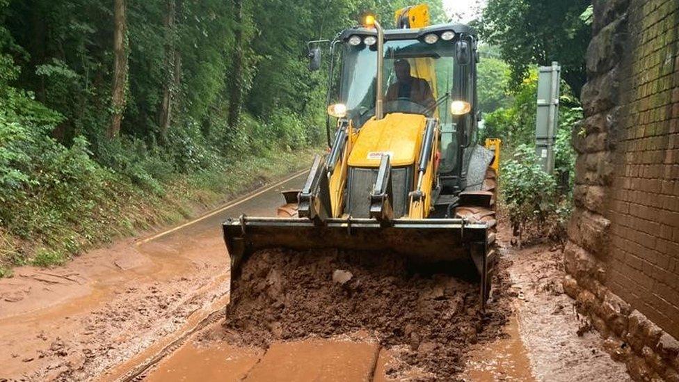 A truck removing debris from the road