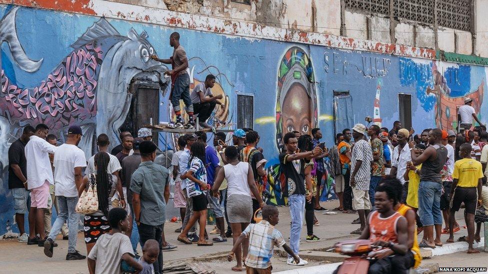 The South African Graffiti Artist Breeze in collaboration with with the Nima Muhinmanchi Art group, spray paints the wall of the delapidated Sea View Hotel as part of Chale Wote Street Art Festival. Accra, Ghana 2015